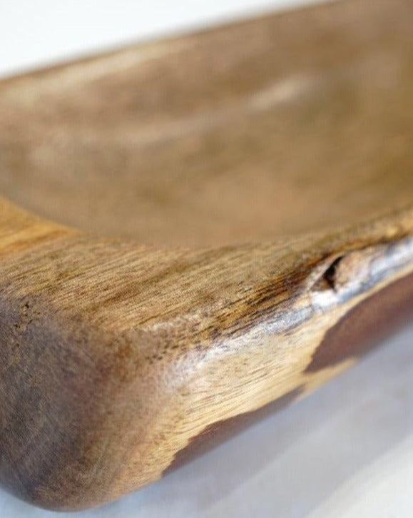 Close-up view of the corner of a handcrafted Timber Grooves Centre Piece Bowl with a smooth finish, showcasing the natural wood grain and texture of the wood.