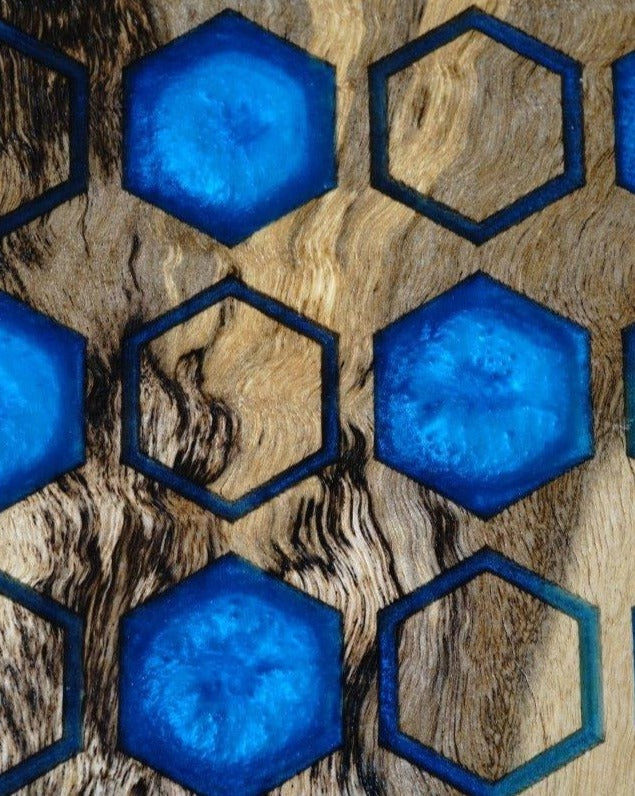 Timber Grooves' Chessboard with Resin Inlay features a handcrafted wooden surface with hexagonal blue resin inlays arranged in a geometric pattern, made from fine Australian hardwood.