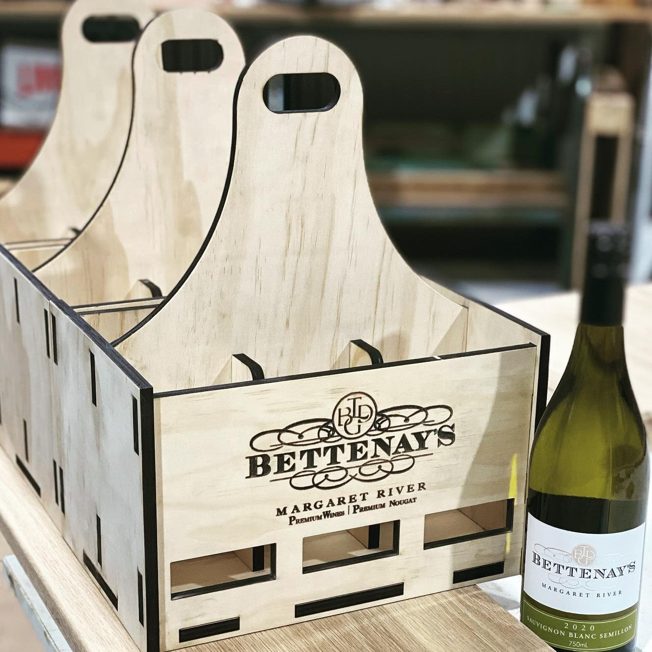 A Personalised Timber Wine Carrier by Timber Grooves is perfectly designed to hold a bottle of Bettenay's Sauvignon Blanc, making it an ideal wine gift.