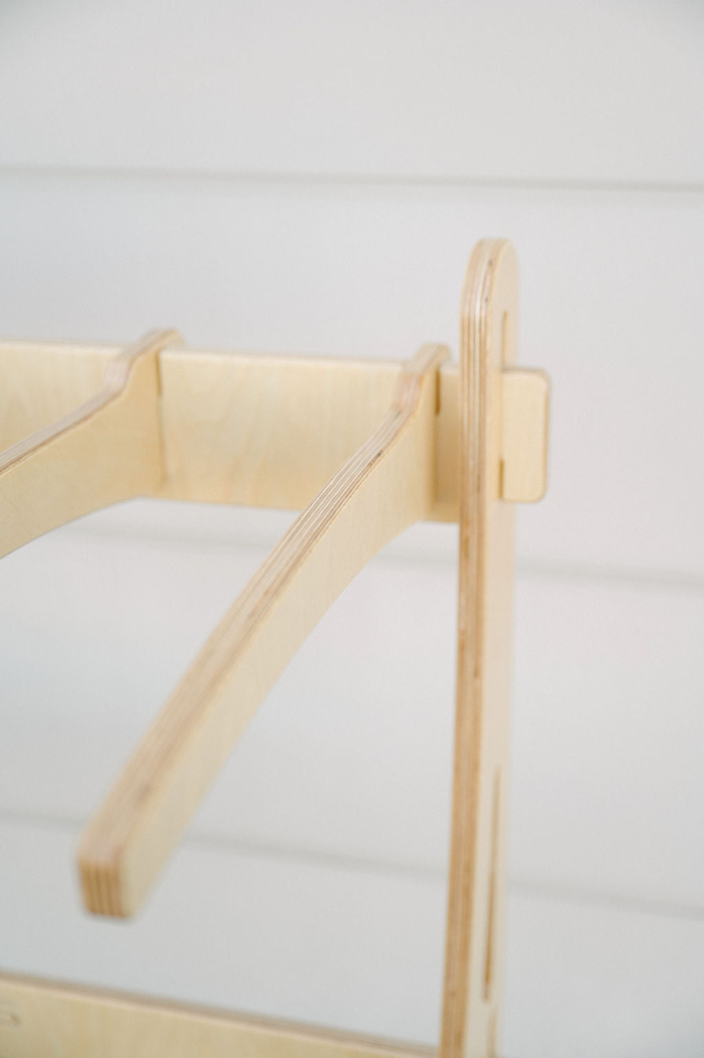 Close-up of a wooden furniture joint, showcasing the interlocking parts and smooth, unfinished wood surface—perfect for those interested in wholesale inquiries for the Surfboard Rack Freestanding by Timber Grooves.