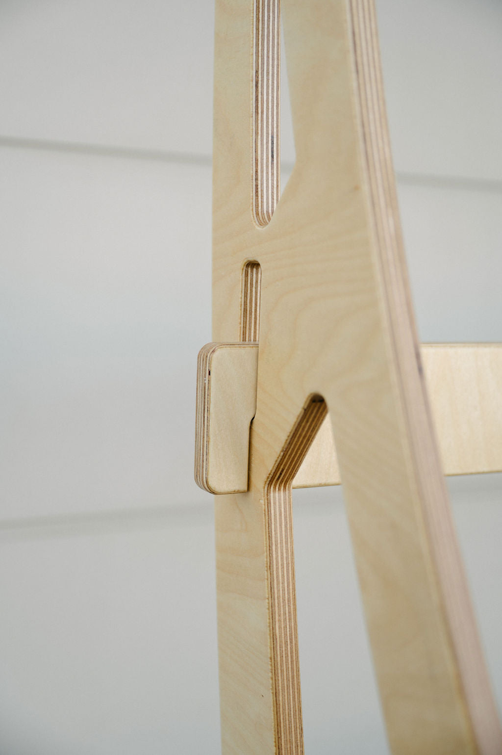 Close-up of a light-colored wood structure with interlocking, precisely cut components against a neutral background, perfect for Timber Grooves Surfboard Rack Freestanding designs or wall-mounted racks.